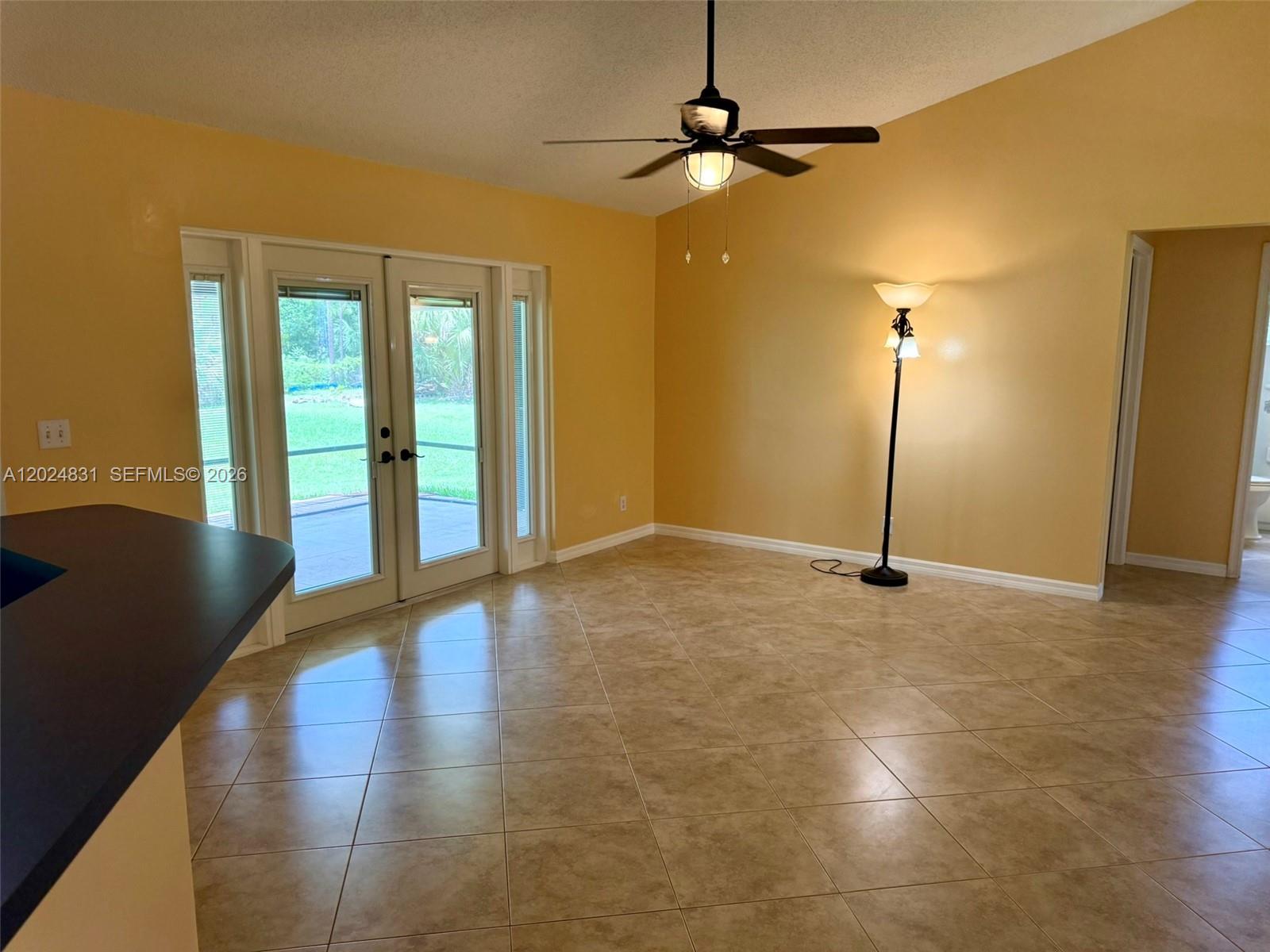15819 76th Road North Loxahatchee, FL 33470 - Photo 13 of 45 a view of an empty room with glass door