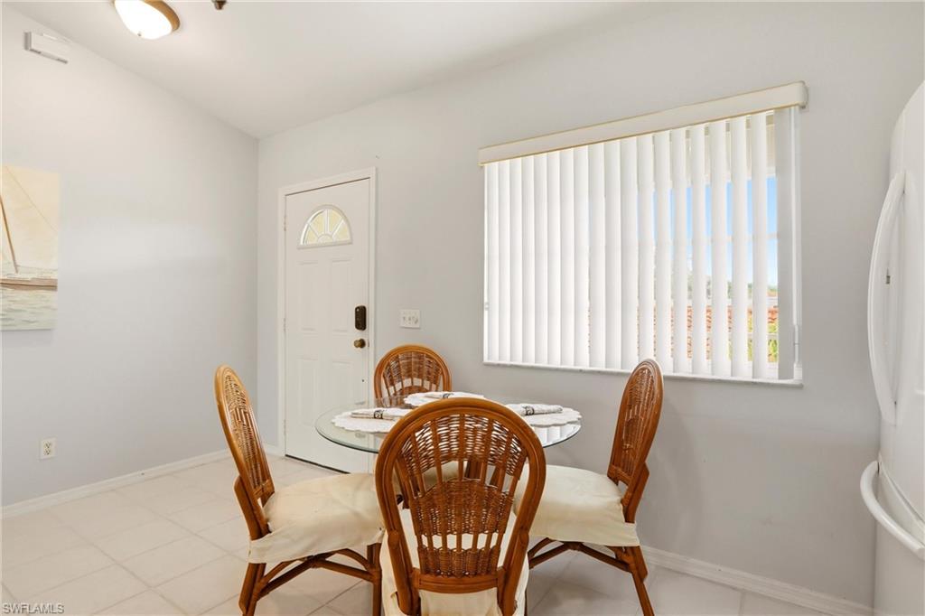 1723 Reuven Circle, Unit 2004 Naples, FL 34112 - Photo 13 of 29 a view of a dining room with furniture and window