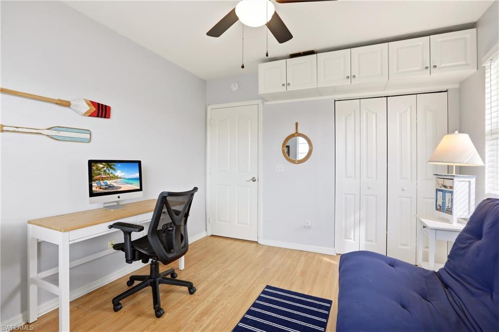 1723 Reuven Circle, Unit 2004 Naples, FL 34112 - Photo 16 of 29 a view of a workspace with furniture and a chandelier fan