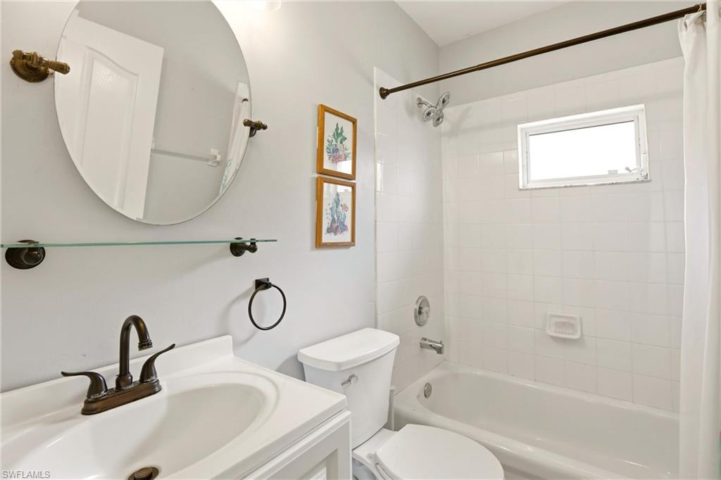 1723 Reuven Circle, Unit 2004 Naples, FL 34112 - Photo 17 of 29 a bathroom with a toilet sink vanity tub and shower