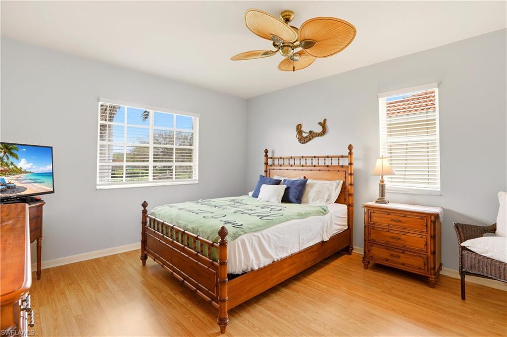 1723 Reuven Circle, Unit 2004 Naples, FL 34112 - Photo 18 of 29 a bedroom with a bed and a chandelier