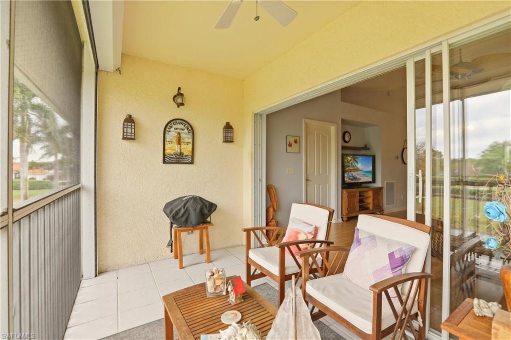 1723 Reuven Circle, Unit 2004 Naples, FL 34112 - Photo 24 of 29 a living room with furniture and a window