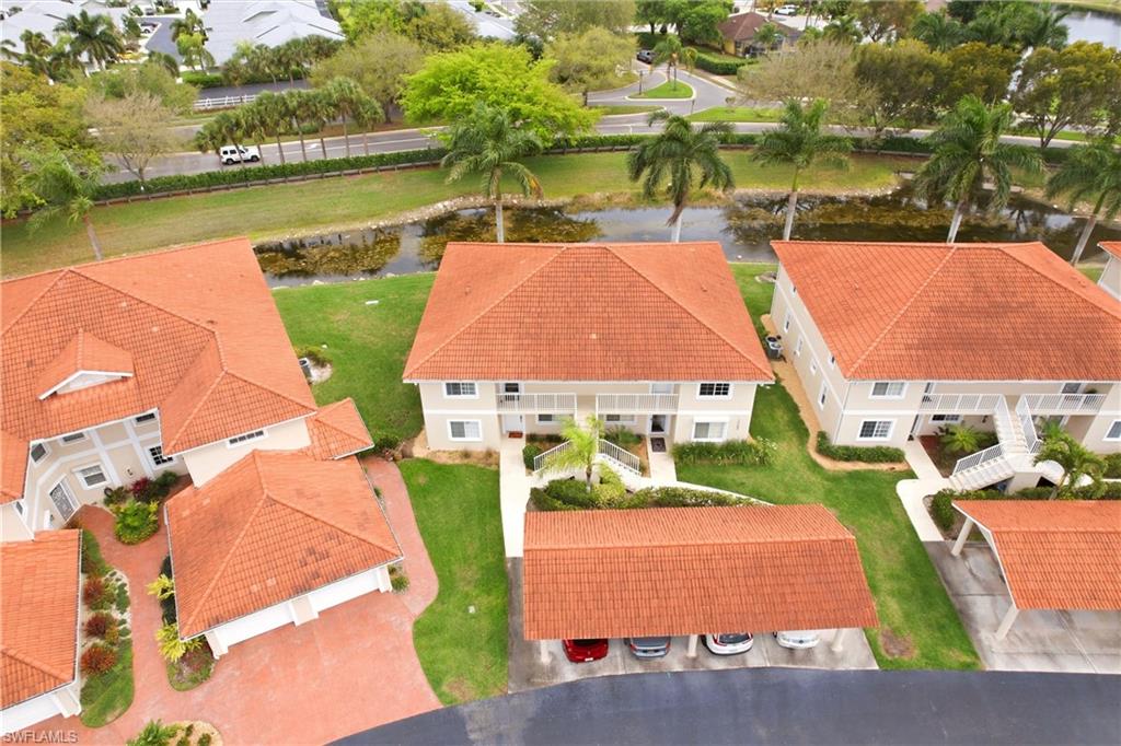 1723 Reuven Circle, Unit 2004 Naples, FL 34112 - Photo 28 of 29 an aerial view of residential houses with outdoor space and lake view