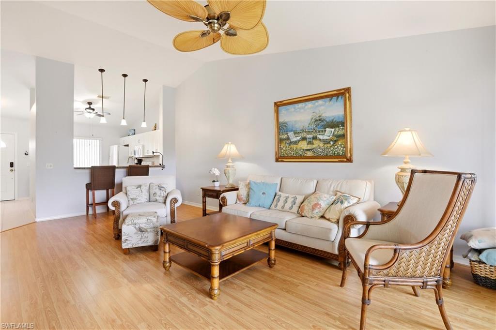 1723 Reuven Circle, Unit 2004 Naples, FL 34112 - Photo 5 of 29 a living room with furniture and a chandelier