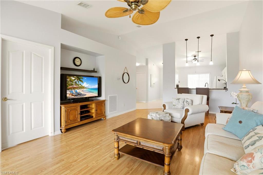 1723 Reuven Circle, Unit 2004 Naples, FL 34112 - Photo 6 of 29 a living room with furniture and a flat screen tv