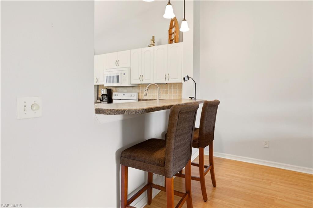 1723 Reuven Circle, Unit 2004 Naples, FL 34112 - Photo 10 of 29 a dining room with table and chairs