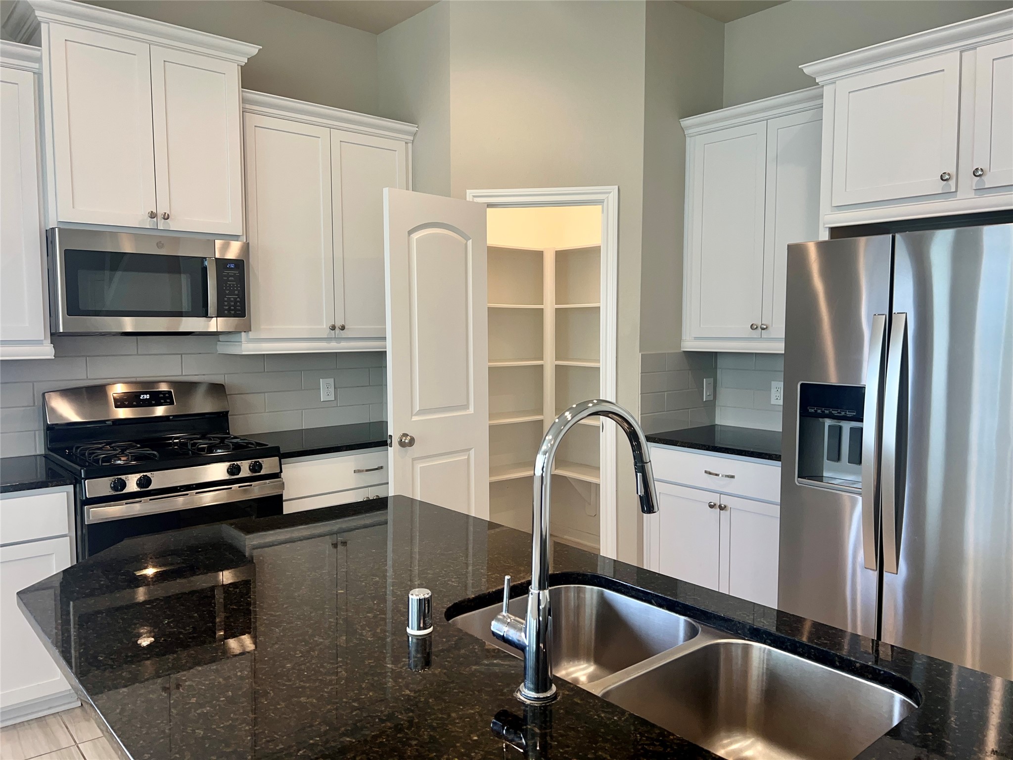 5255 Prairie Terrace Lane Fulshear, TX 77441 - Photo 5 of 28 Closeup of kitchen showing the walk-in pantry.