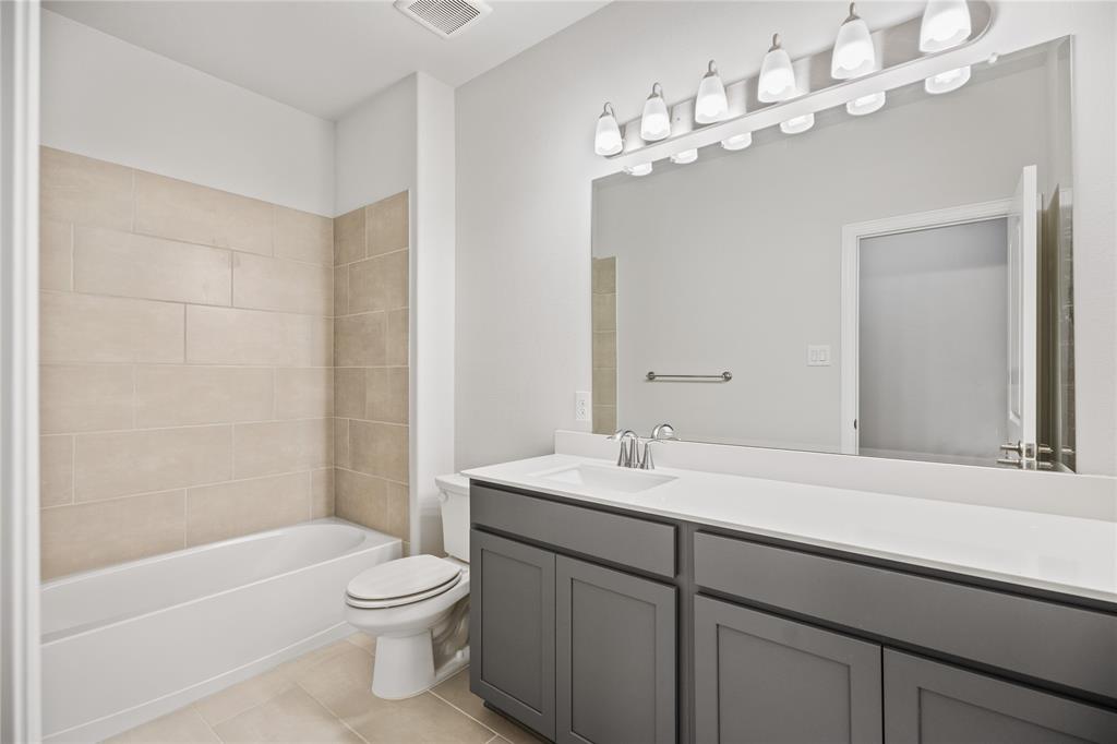 2608 Freeman Street Anna, TX 75409 - Photo 18 of 22 a bathroom with a sink a toilet and shower