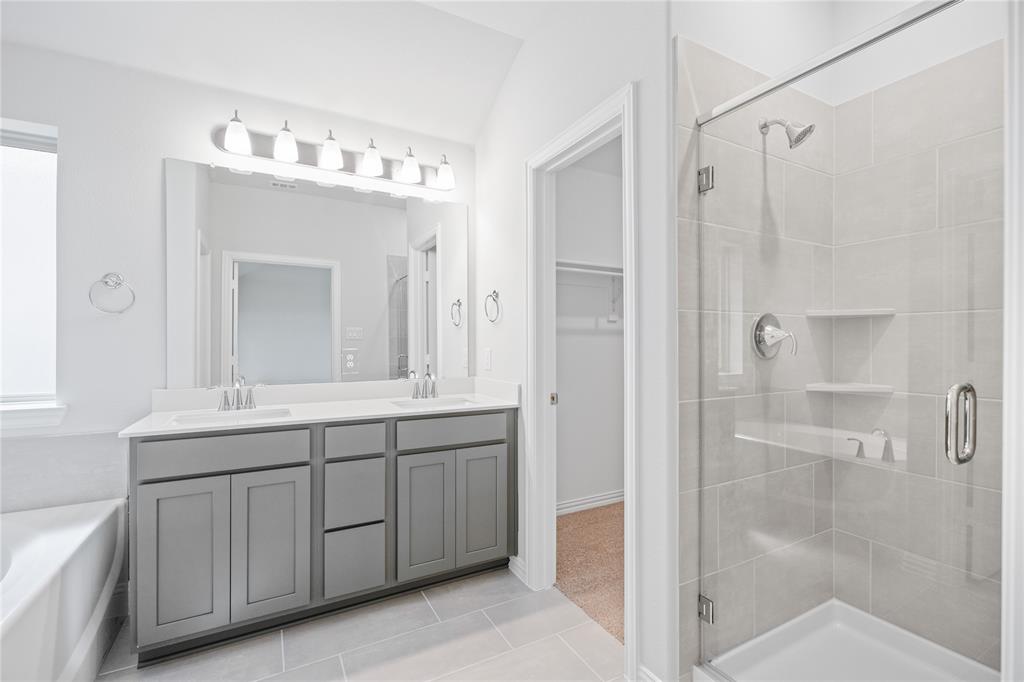 2608 Freeman Street Anna, TX 75409 - Photo 19 of 22 a bathroom with a double vanity sink mirror and shower
