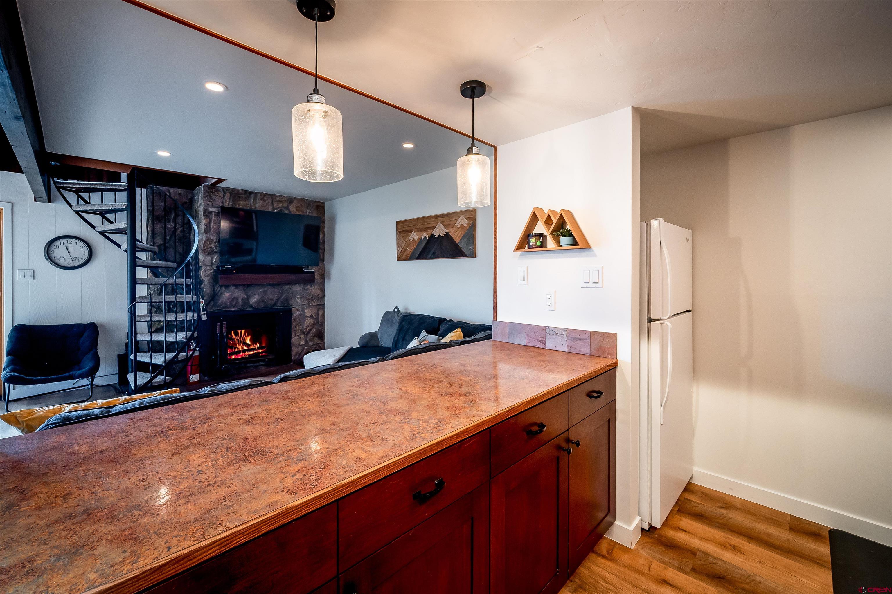 44 Sheol Street, Unit A22 Durango, CO 81301 - Photo 11 of 34 a kitchen with stainless steel appliances granite countertop a sink and a refrigerator