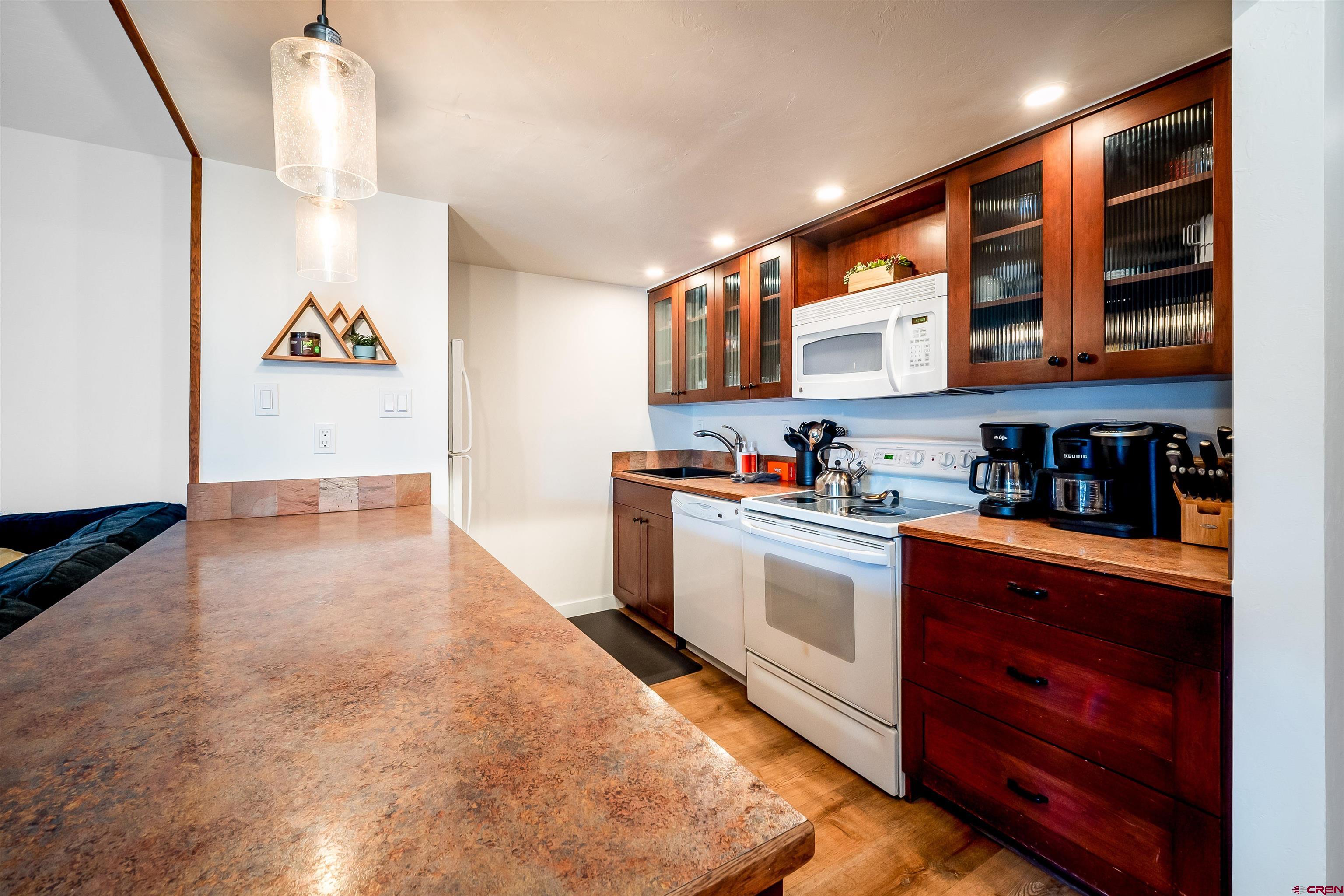 44 Sheol Street, Unit A22 Durango, CO 81301 - Photo 12 of 34 a kitchen with stainless steel appliances granite countertop a stove and cabinets