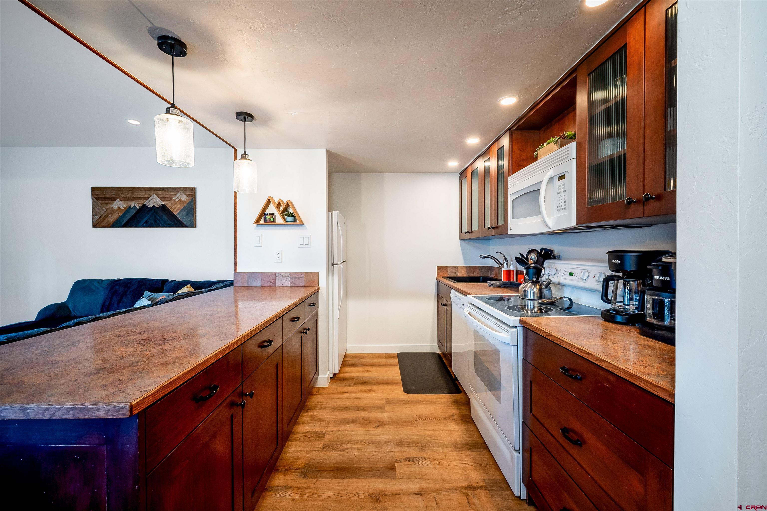 44 Sheol Street, Unit A22 Durango, CO 81301 - Photo 13 of 34 a kitchen with stainless steel appliances granite countertop a stove and a sink