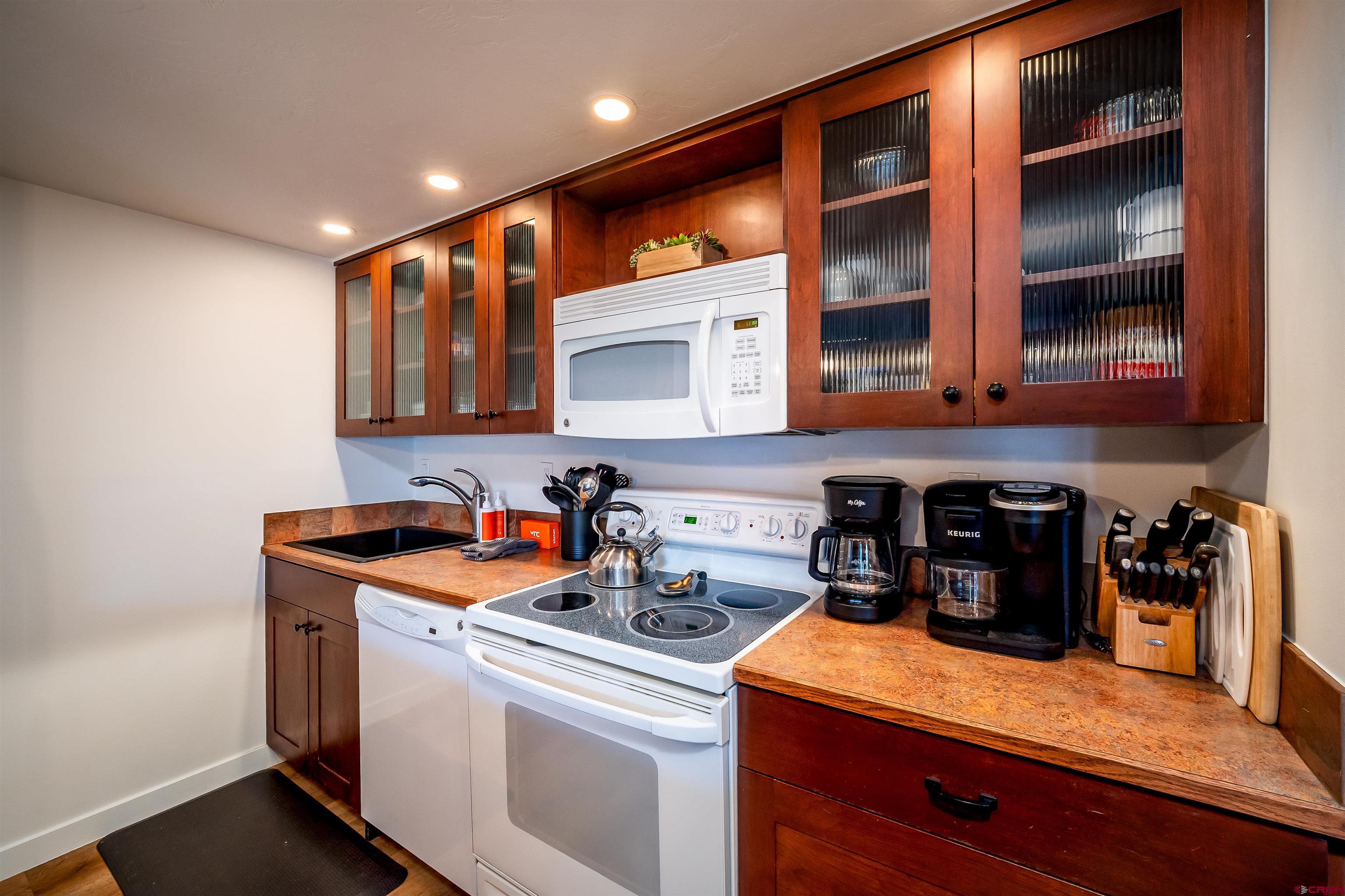 44 Sheol Street, Unit A22 Durango, CO 81301 - Photo 14 of 34 a kitchen with stainless steel appliances granite countertop a sink and cabinets