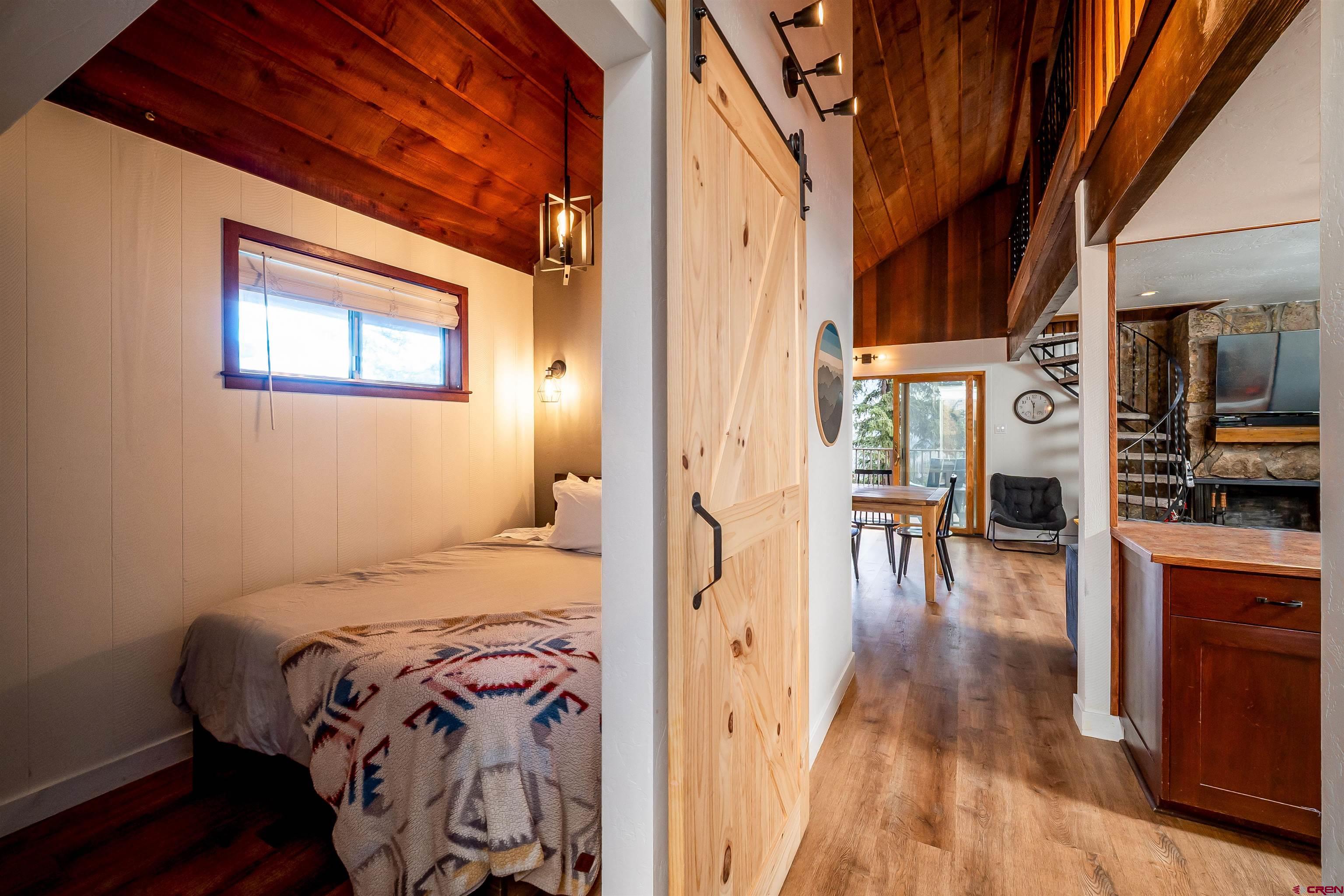 44 Sheol Street, Unit A22 Durango, CO 81301 - Photo 16 of 34 a bedroom with a bed and wooden floor