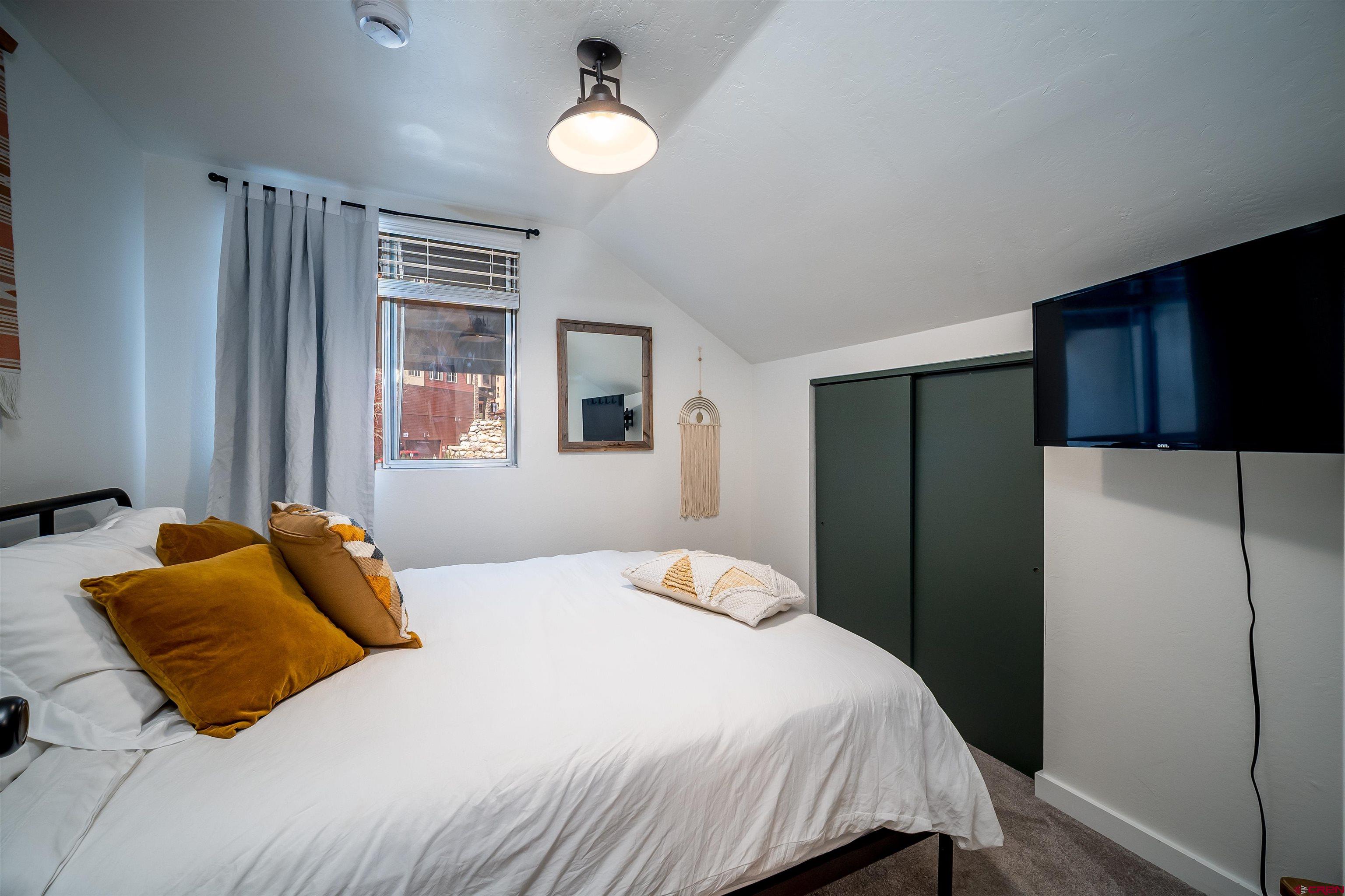 44 Sheol Street, Unit A22 Durango, CO 81301 - Photo 22 of 34 a bedroom with a bed and a refrigerator