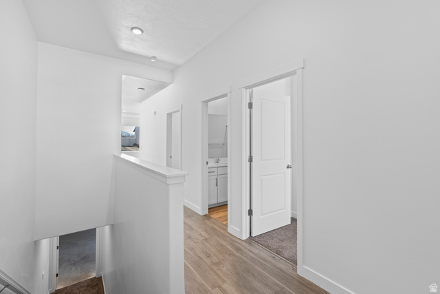 2823 North 710 West, Unit 16 Logan, UT 84321 - Photo 4 of 22 Hall with an upstairs landing and light wood finished floors
