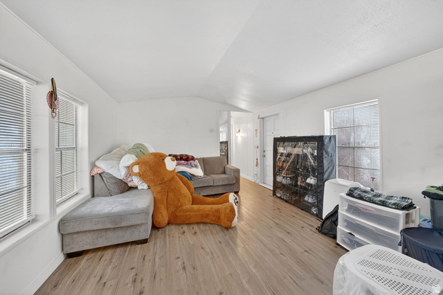 262 Hidden View Drive, Unit 94 Sandy, UT 84070 - Photo 5 of 18 Living area with vaulted ceiling and wood finished floors
