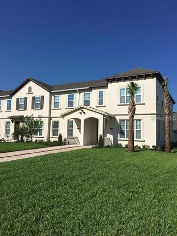 a view of a house with a big yard and large trees
