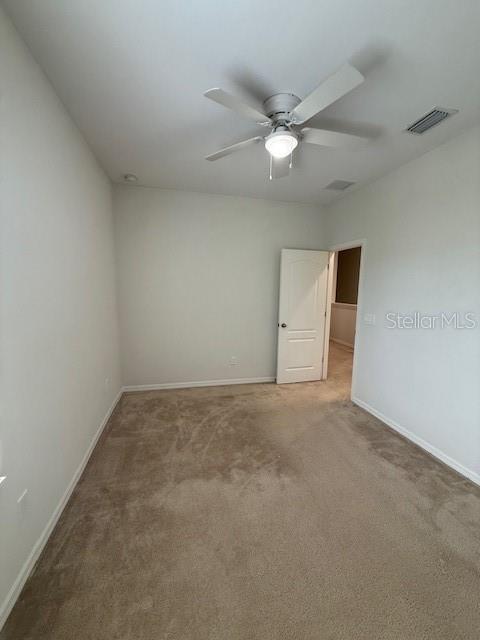 7231 Shadeview Alley Windermere, FL 34786 - Photo 13 of 22 an empty room with a fan and a ceiling fan