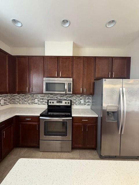 7231 Shadeview Alley Windermere, FL 34786 - Photo 5 of 22 a kitchen with wooden cabinets and stainless steel appliances
