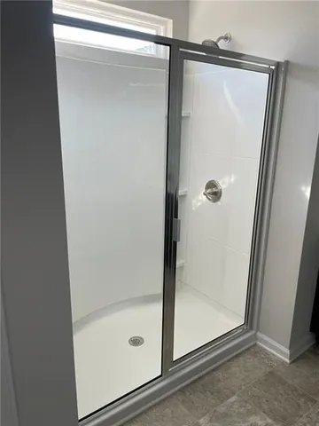 a bathroom with a glass shower door