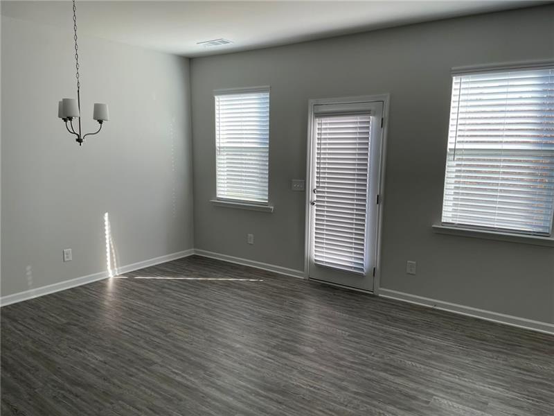 92 Shelter Lane East Dawsonville, GA 30534 - Photo 3 of 19 an empty room with wooden floor and windows