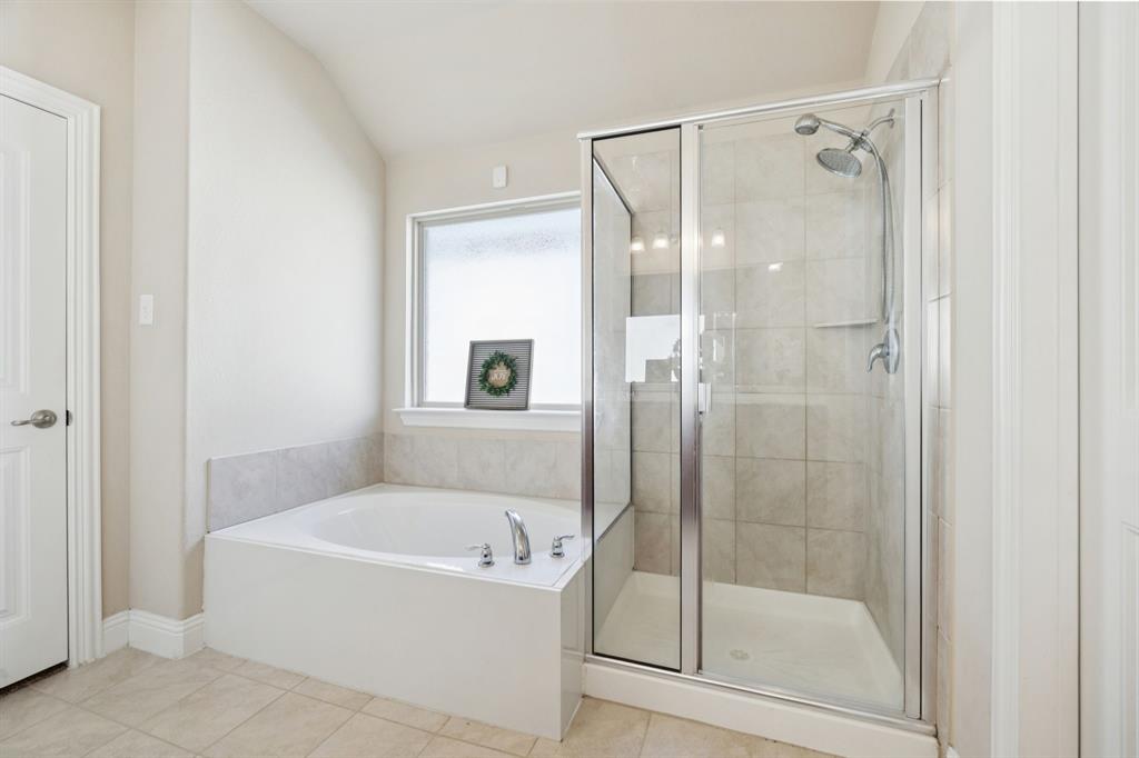 4017 Netherfield Road Frisco, TX 75036 - Photo 15 of 29 a bathroom with a bathtub and a shower