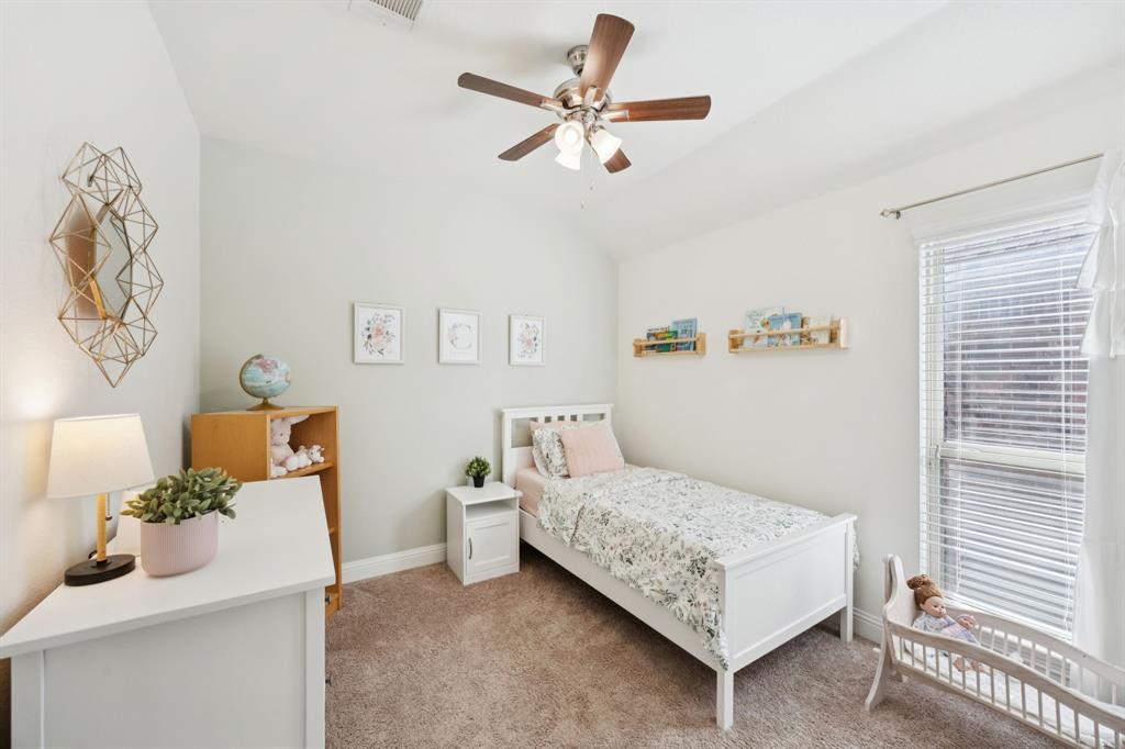 4017 Netherfield Road Frisco, TX 75036 - Photo 16 of 29 a bedroom with a bed and a chandelier
