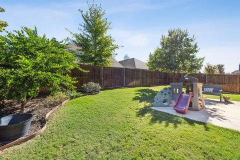 a view of a house with sitting area and garden