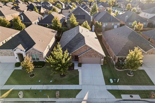 an aerial view of residential houses with outdoor space