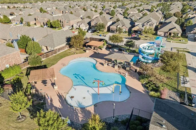 an aerial view of a house with a swimming pool