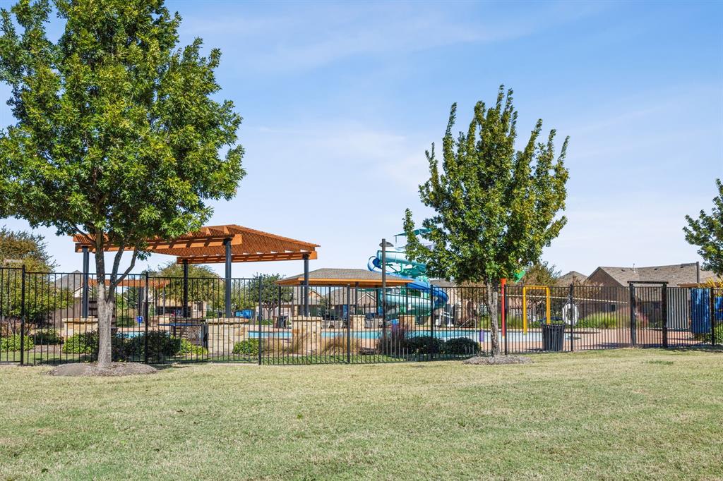 4017 Netherfield Road Frisco, TX 75036 - Photo 29 of 29 a view of a park with a table and chairs under an umbrella