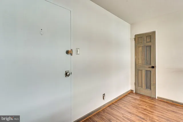 a view of a room with wooden floor