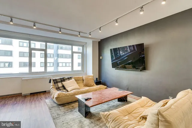 a bedroom with a bed and glass window