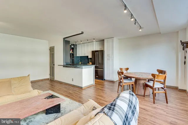 a living room with furniture and kitchen view