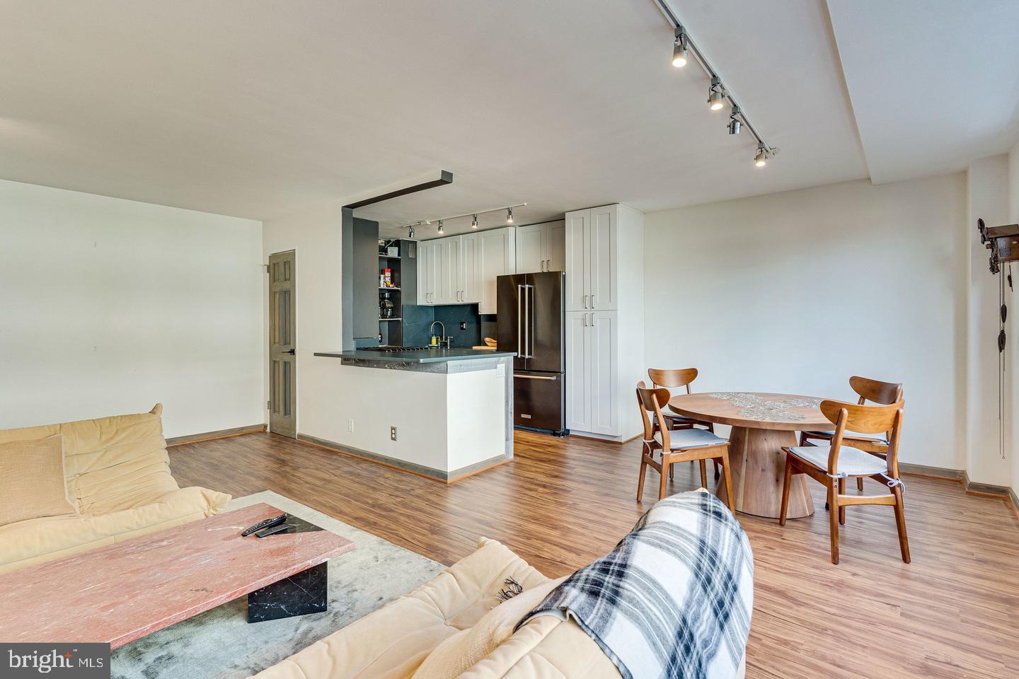 1545 18th Street Northwest, Unit 403 Washington, DC 20036 - Photo 18 of 44 a living room with furniture and kitchen view