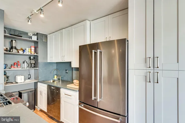 a kitchen with a refrigerator and cabinets