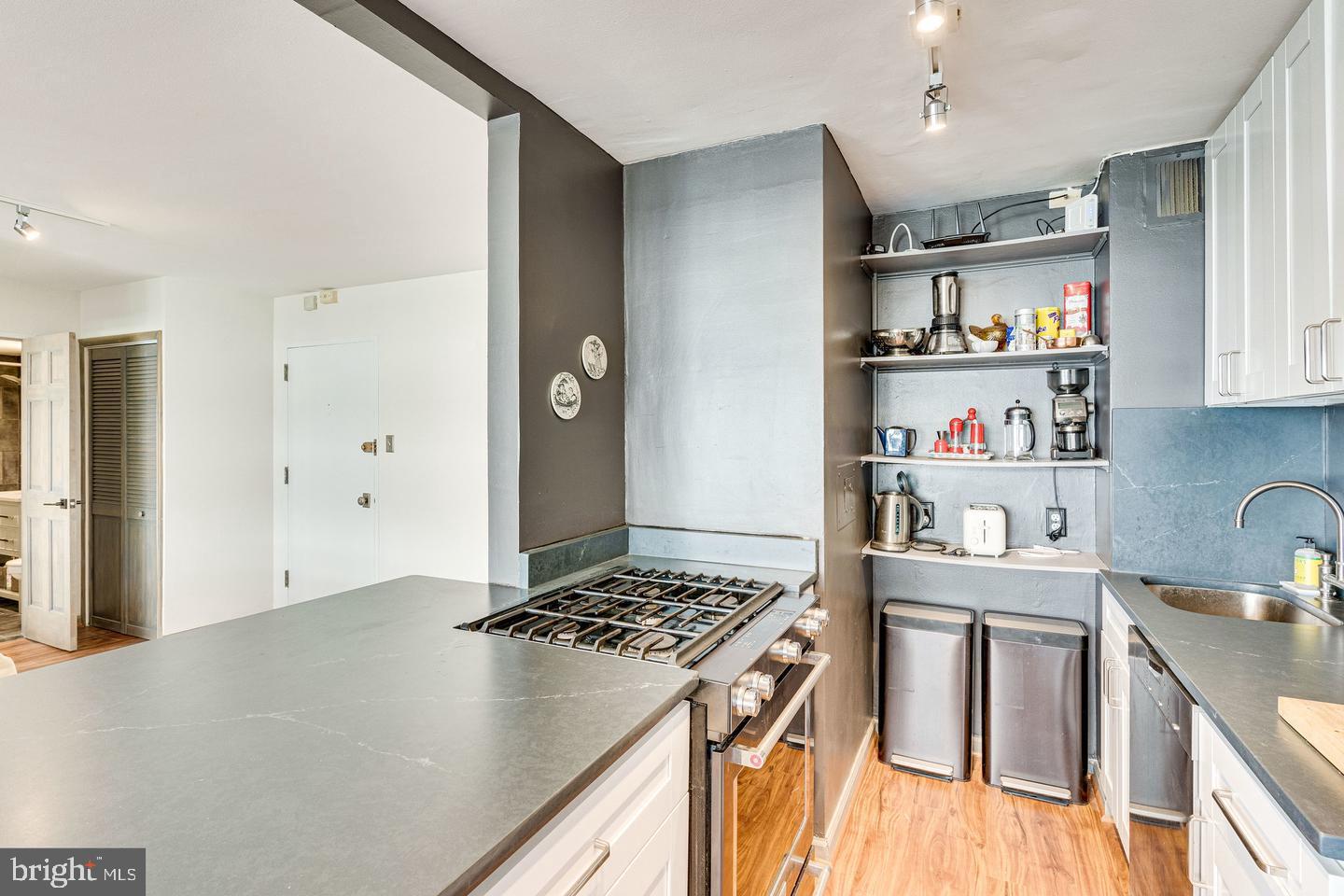 1545 18th Street Northwest, Unit 403 Washington, DC 20036 - Photo 26 of 44 a kitchen with stainless steel appliances granite countertop a sink stove and refrigerator