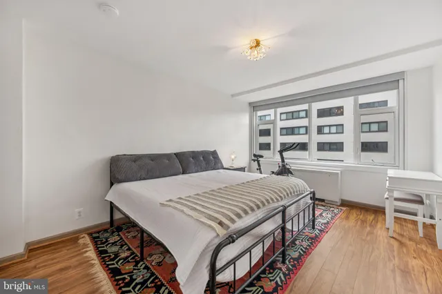 a bed sitting in a bedroom next to a window