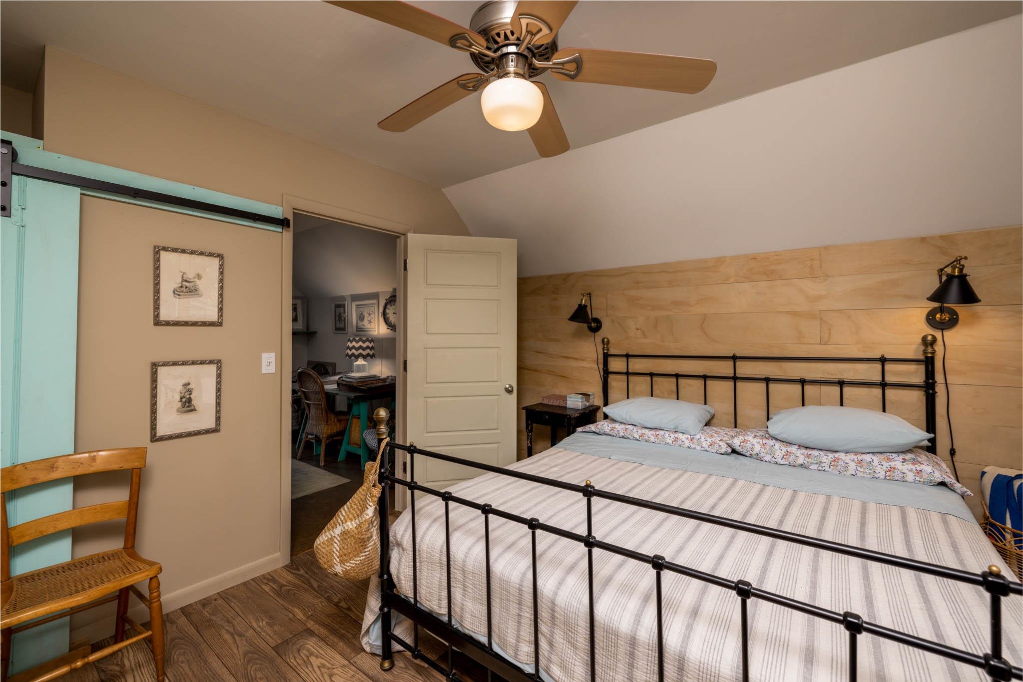 29 Cedarbrook Road Cape May, NJ 08204 - Photo 17 of 28 a bed room with a bed and a chandelier