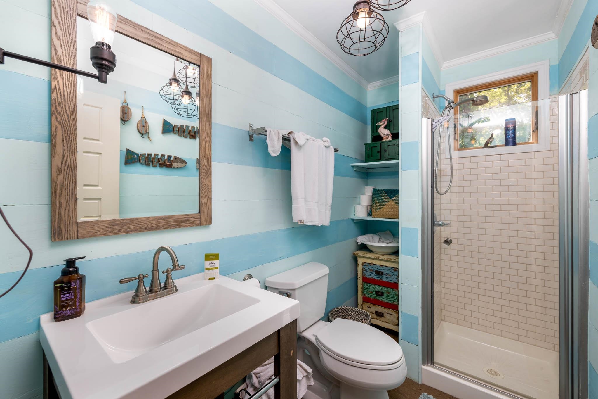 29 Cedarbrook Road Cape May, NJ 08204 - Photo 19 of 28 a bathroom with a sink a toilet and a mirror