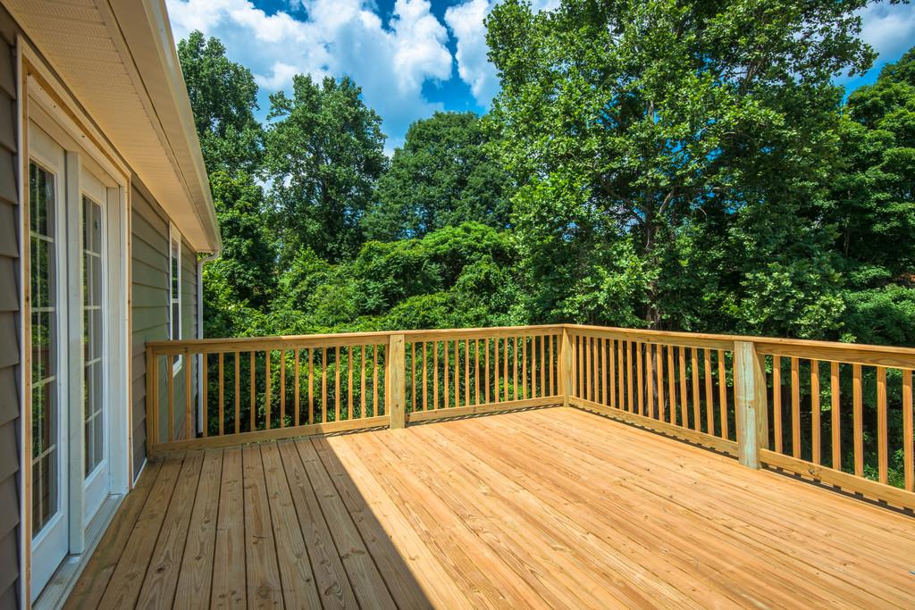 807 Blakemore Road Dickson, TN 37055 - Photo 18 of 26 a balcony with wooden floor and trees in the background
