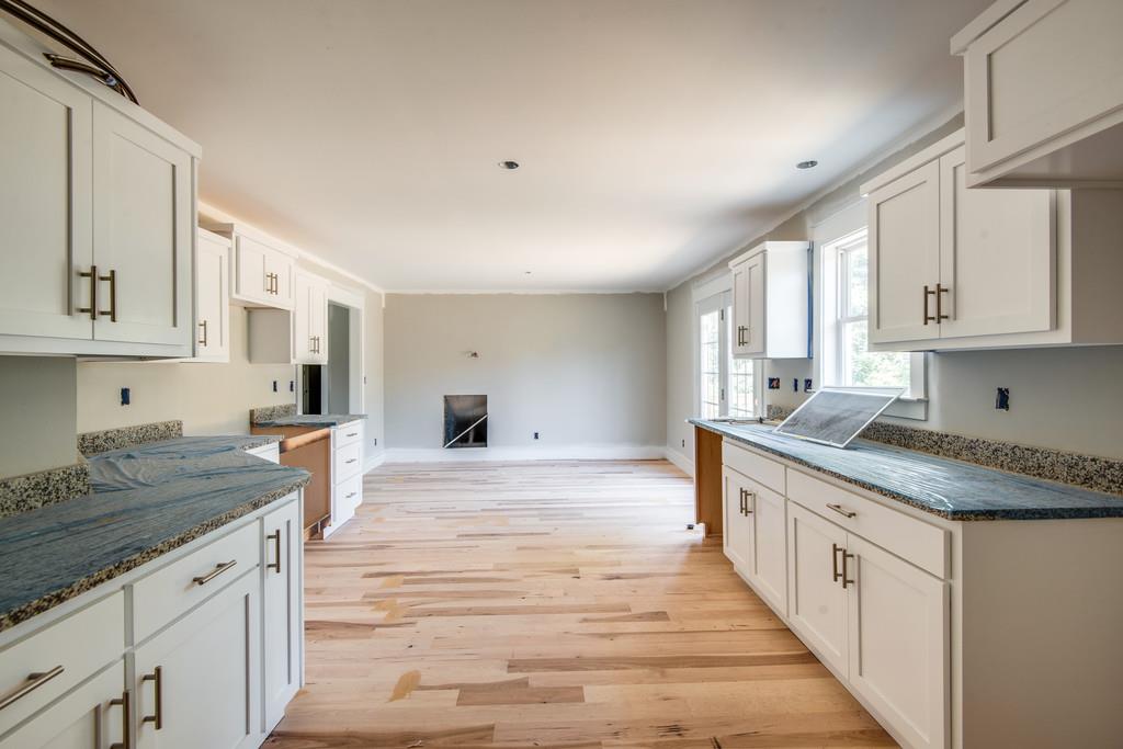807 Blakemore Road Dickson, TN 37055 - Photo 3 of 26 a kitchen with stainless steel appliances granite countertop a stove and white cabinets