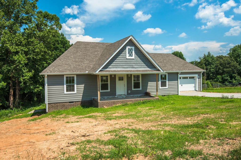 807 Blakemore Road Dickson, TN 37055 - Photo 23 of 26 a front view of a house with a garden and yard