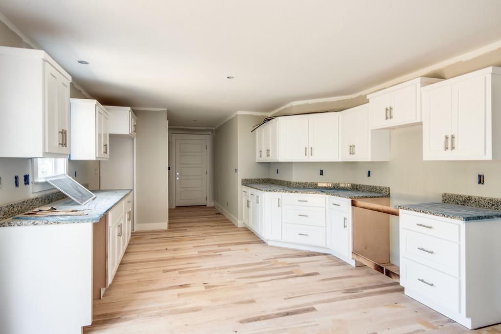 807 Blakemore Road Dickson, TN 37055 - Photo 5 of 26 a kitchen with granite countertop a sink stove top oven and cabinets