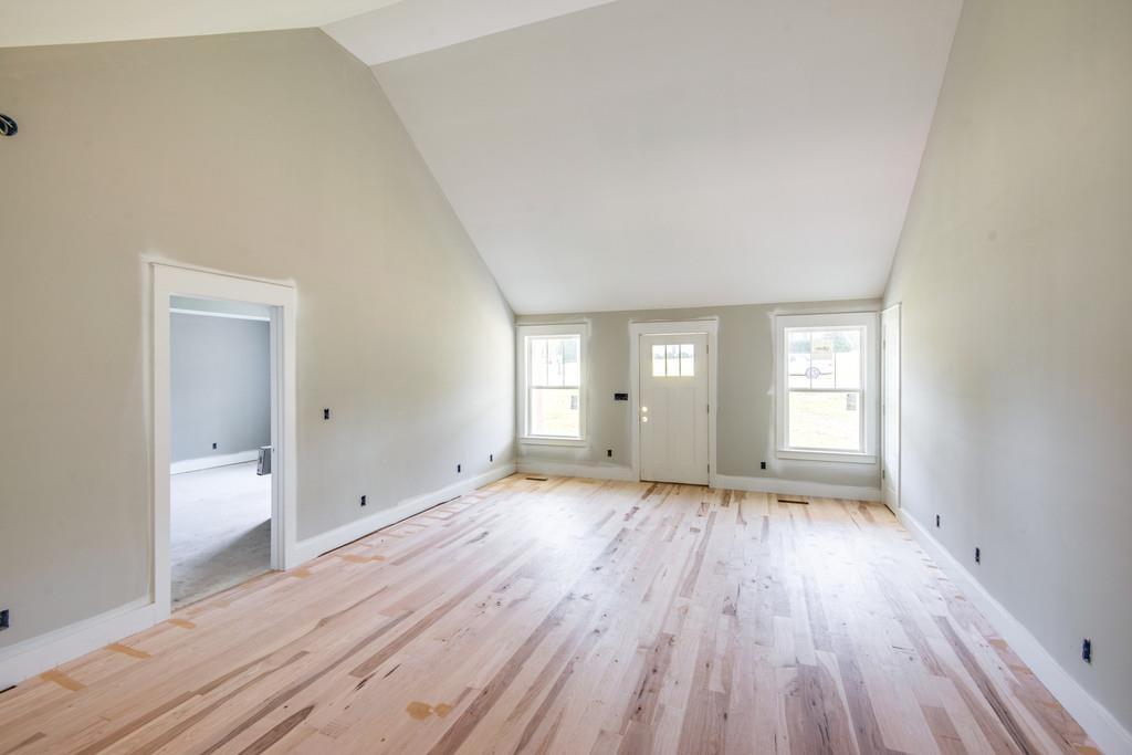 807 Blakemore Road Dickson, TN 37055 - Photo 7 of 26 a view of empty room with window and wooden floor