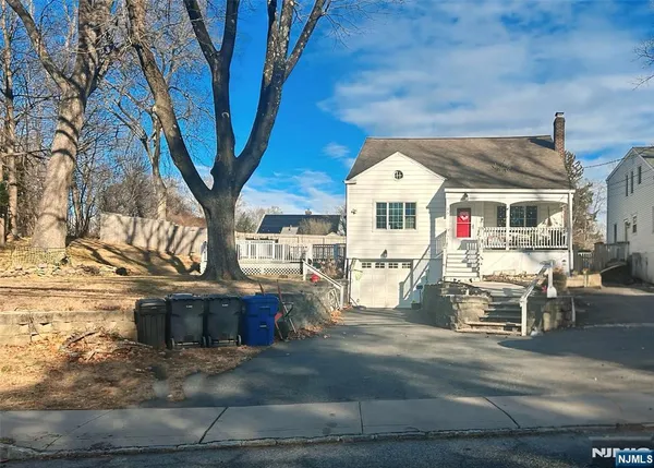 a front view of a house with outdoor seating