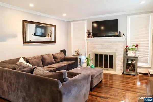 a living room with fireplace furniture and a flat screen tv