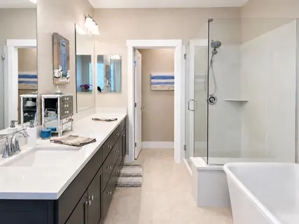 a bathroom with a granite countertop sink a bathtub and shower