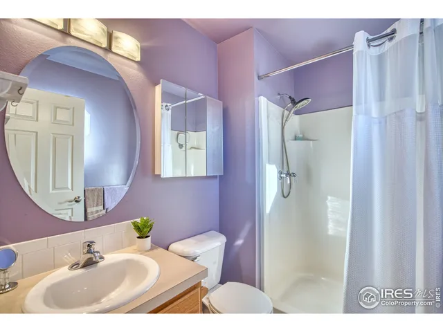a bathroom with a sink vanity tub and shower
